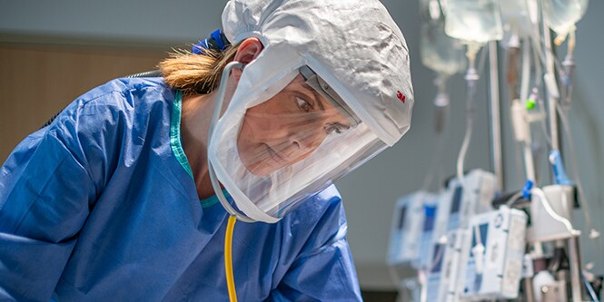 Clinician wearing a powered air-purifying respirator
