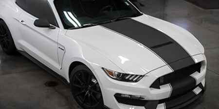 White car with black stripe accent
