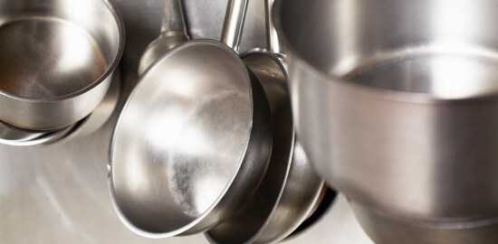 A man washing dishes in a commercial kitchen
