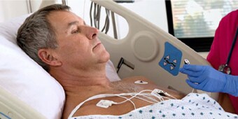 Clinician closely monitoring a patient
