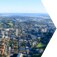 Overhead panoramic view of a city with horizon in the background.