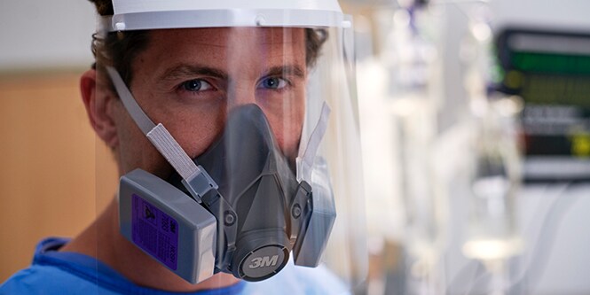 Clinician wearing a half facepiece resuable respirator
