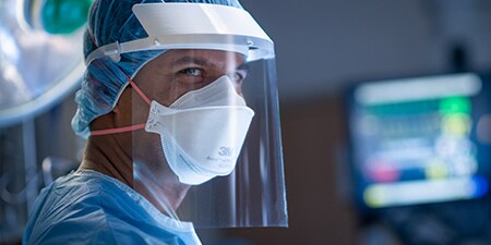 Clinician wearing a filtering facepiece respirator and faceshield
