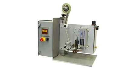 Image of a pad applicator with a space underneath one end for workpieces to move through
