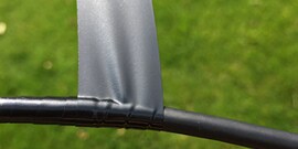 Scotch® Vinyl Electrical Tape Super 33+™ being wrapped around a cable outside