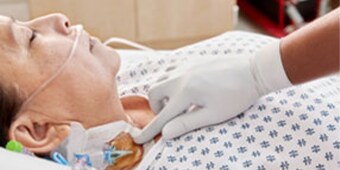Clinician monitoring a patient with a catheter
